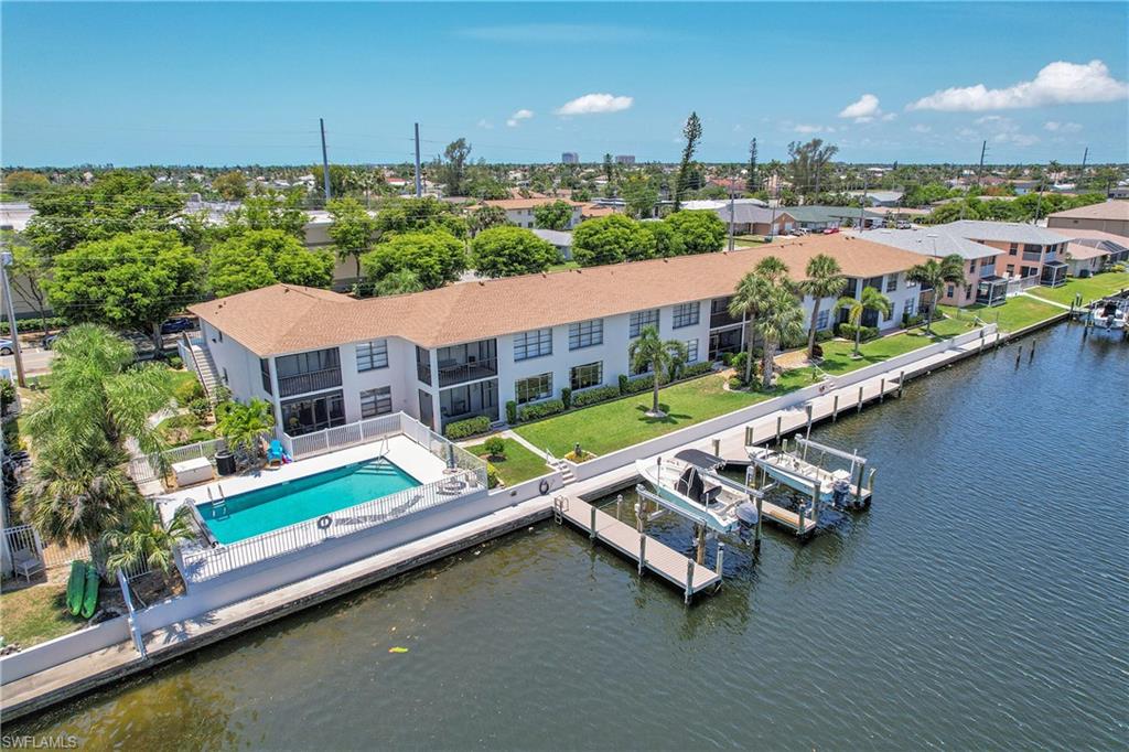 Bird's eye view of community pool, docks and body of water