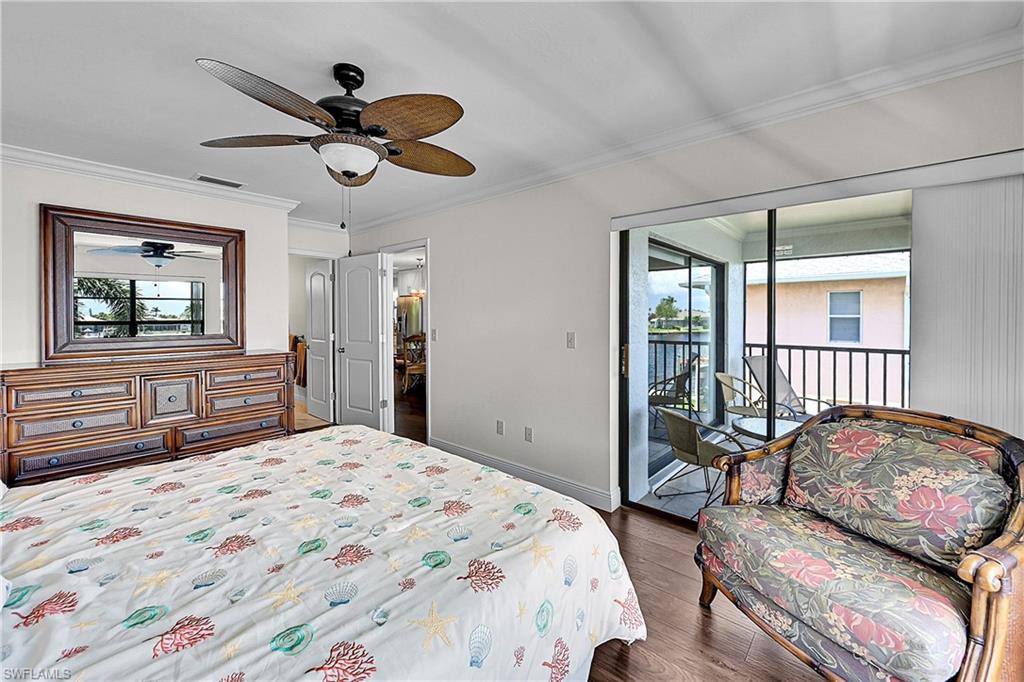 Bedroom with access to exterior, wood finished floors, crown molding, baseboards, and a ceiling fan