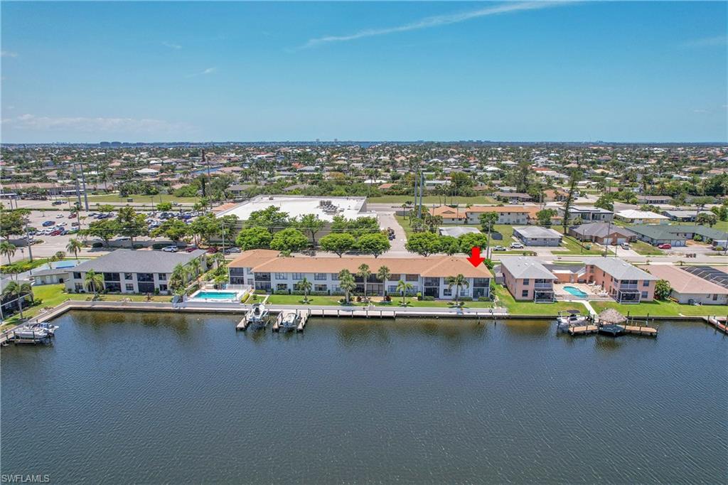 Aerial perspective of suburban area featuring a nearby body of water