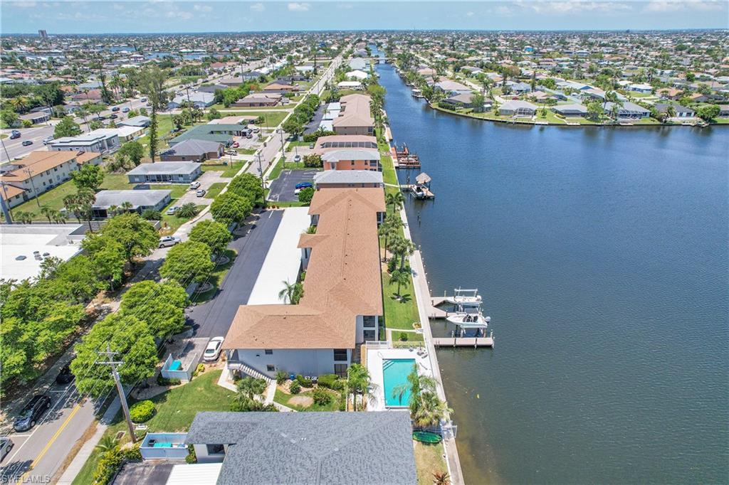 Aerial perspective of suburban area featuring a nearby body of water