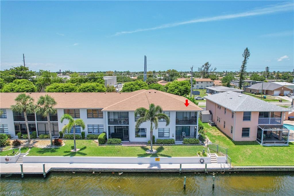 Aerial view of residential area featuring a nearby body of water