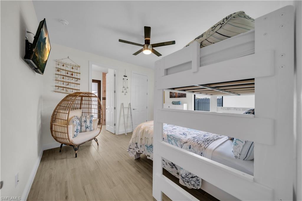 Bedroom with baseboards, wood finished floors, and ceiling fan