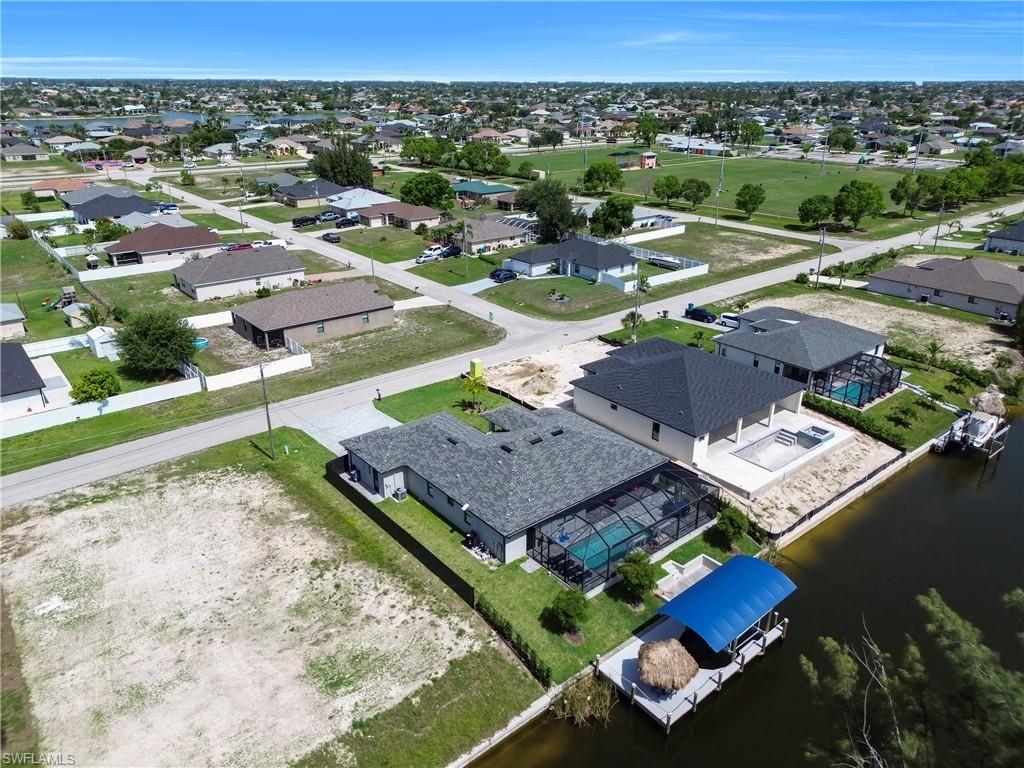 Aerial perspective of suburban area featuring a large body of water