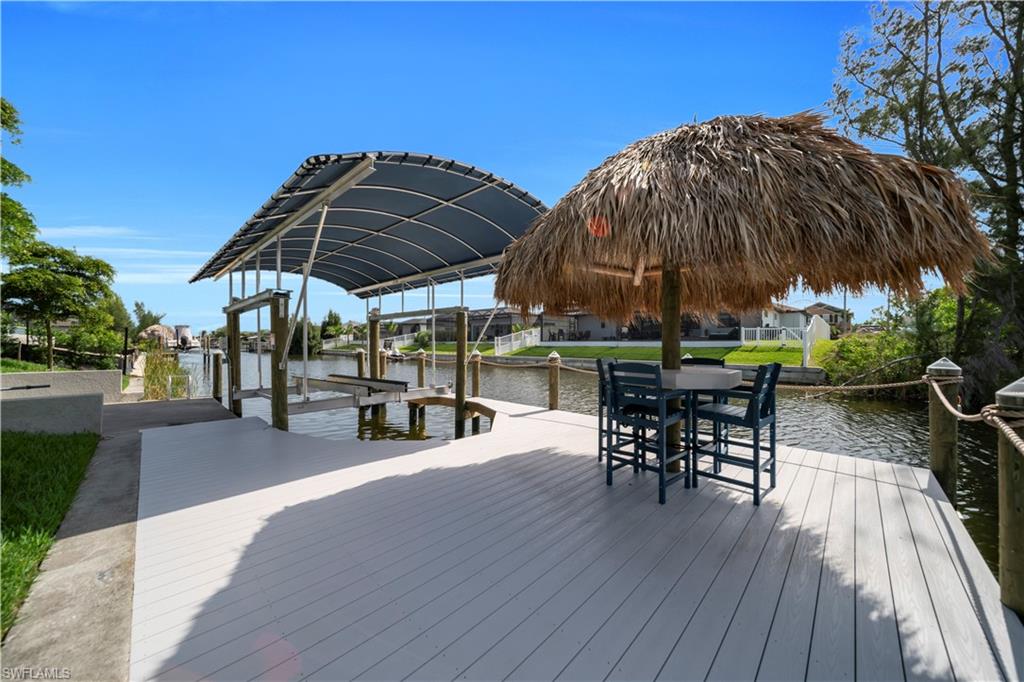 Dock area with boat lift and a water view