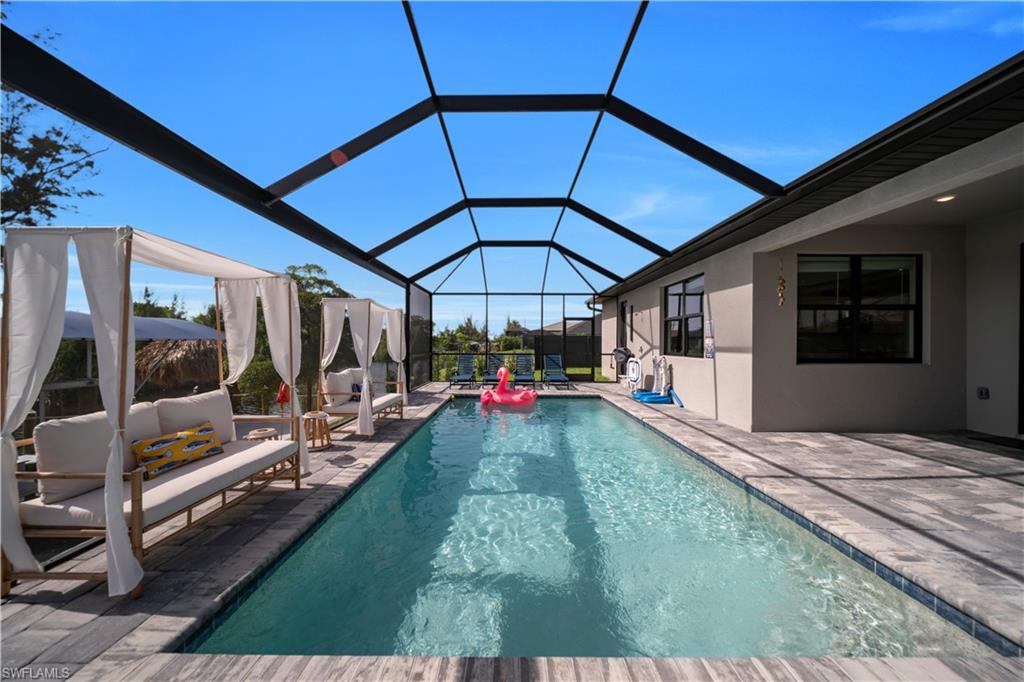 Outdoor pool featuring a patio, a lanai, and an outdoor hangout area