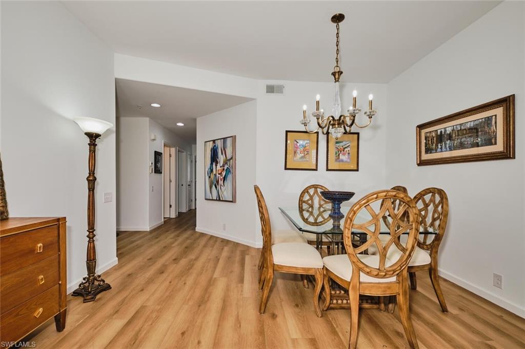 Dining room with light wood-style flooring, baseboards, a chandelier, and recessed lighting