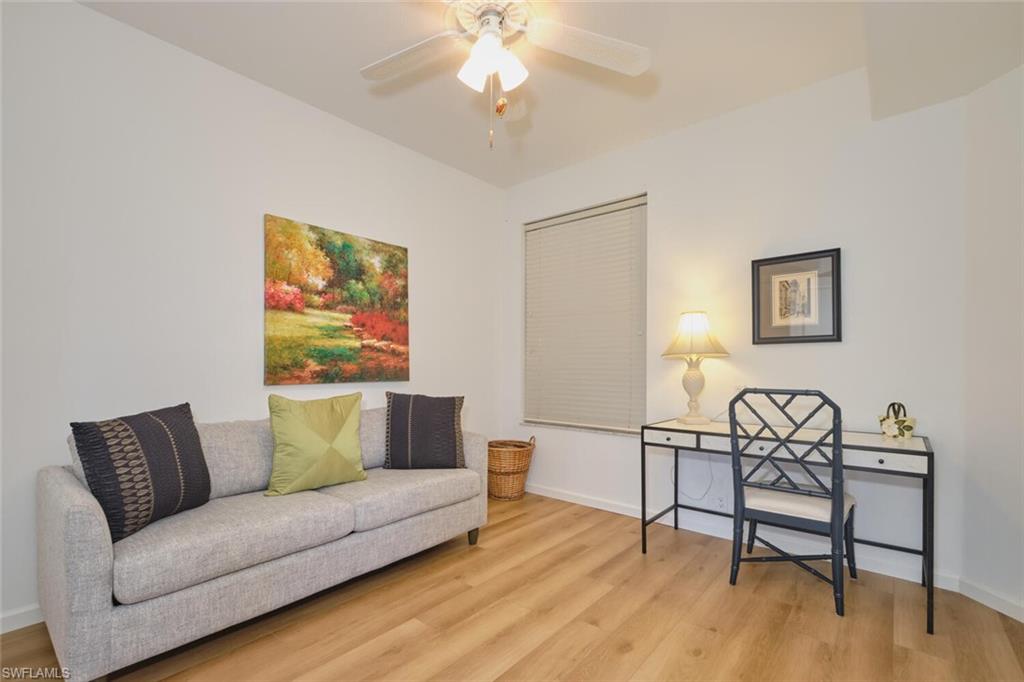 Sitting room with light wood-style floors, ceiling fan, and baseboards