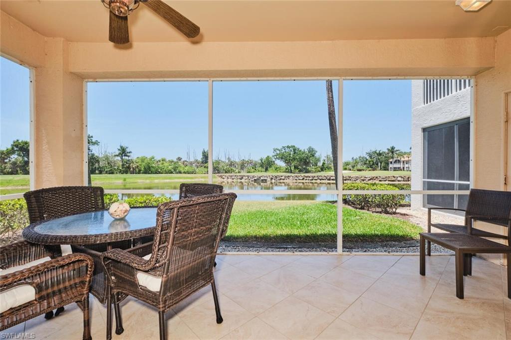 Sunroom / solarium with ceiling fan, a water view, and outdoor dining area
