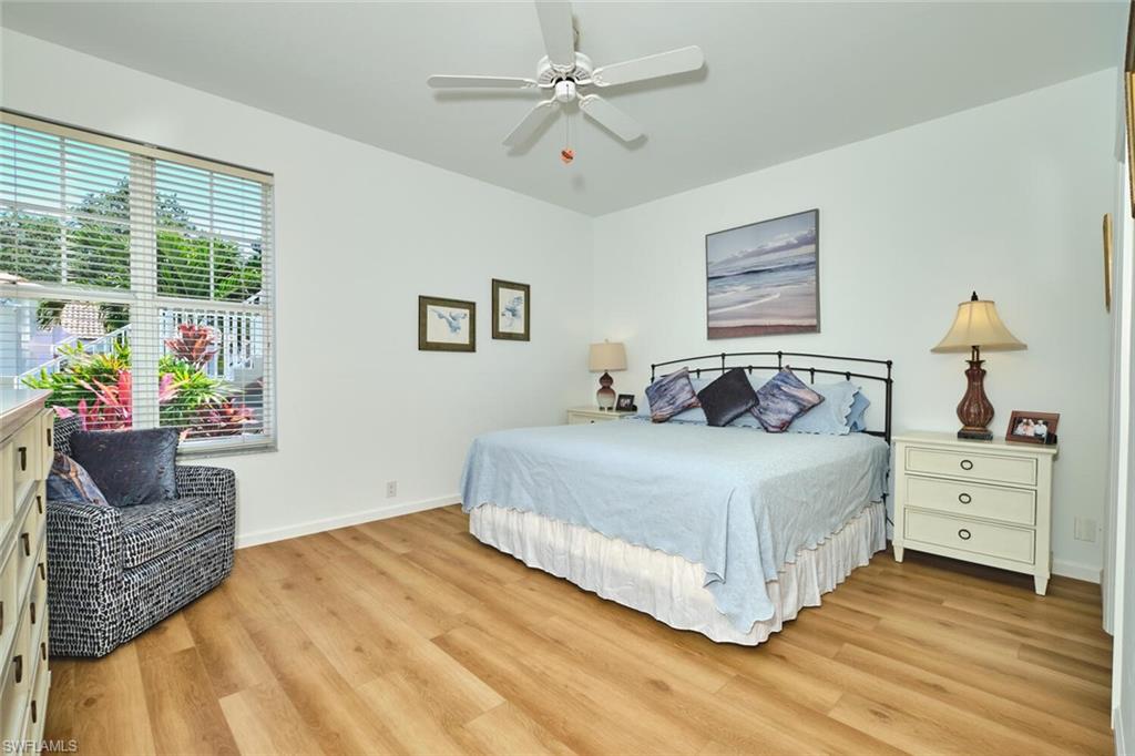 Bedroom featuring light wood-type flooring, baseboards, and ceiling fan