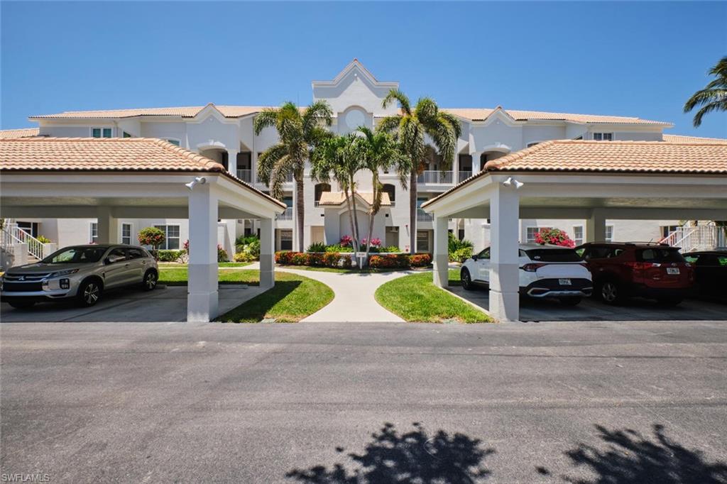 View of property featuring covered parking and a residential view