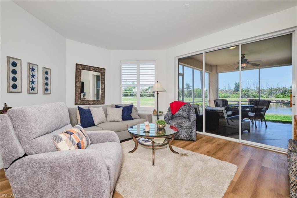 Living room with wood finished floors and a ceiling fan