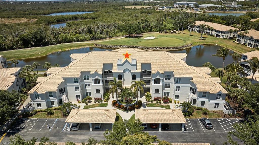 Drone / aerial view of a nearby body of water and a golf club