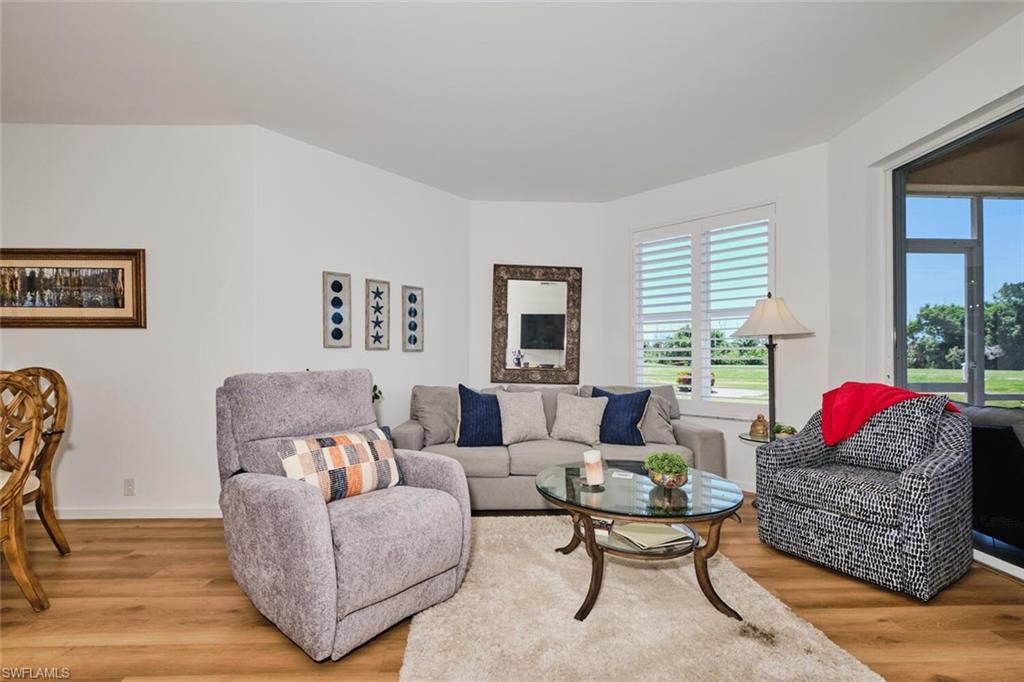 Living area with light wood finished floors, plenty of natural light, and baseboards