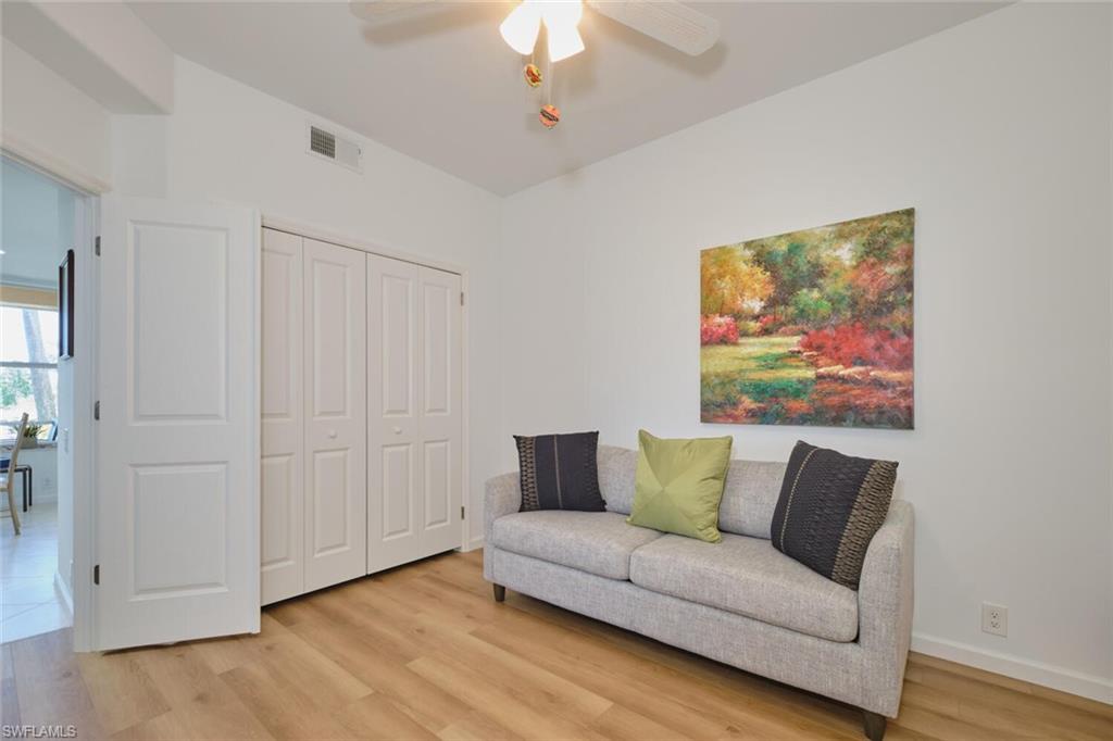 Sitting room with ceiling fan and light wood-style floors