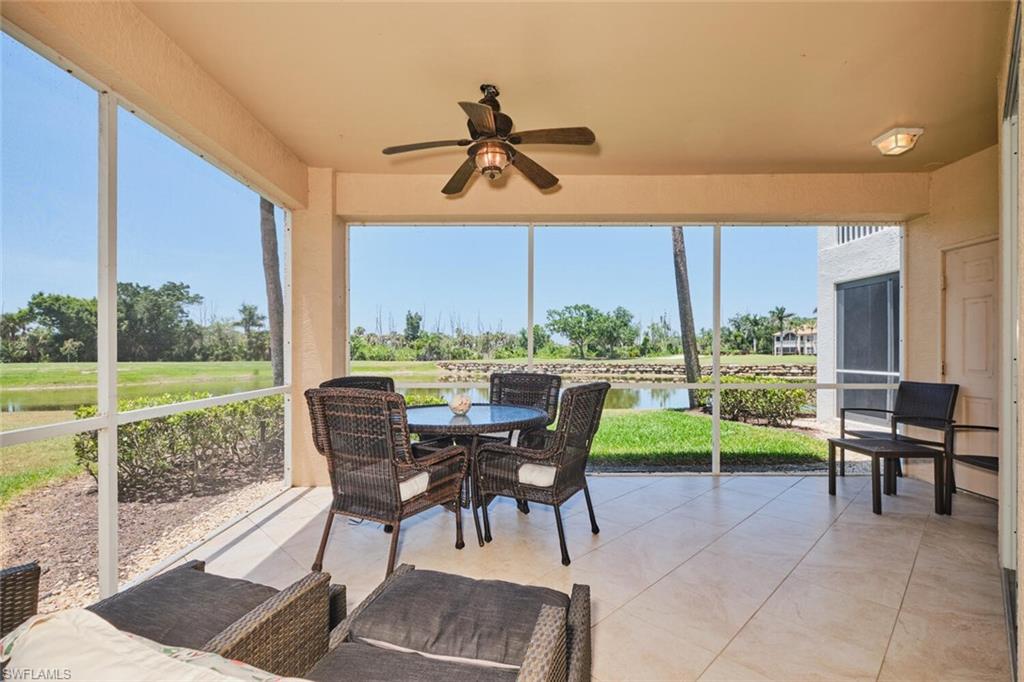 Sunroom with a ceiling fan, a water view, and outdoor dining space