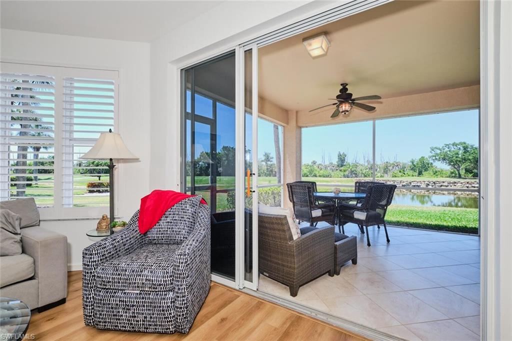 Sunroom / solarium featuring a water view, healthy amount of natural light, and wood finished floors