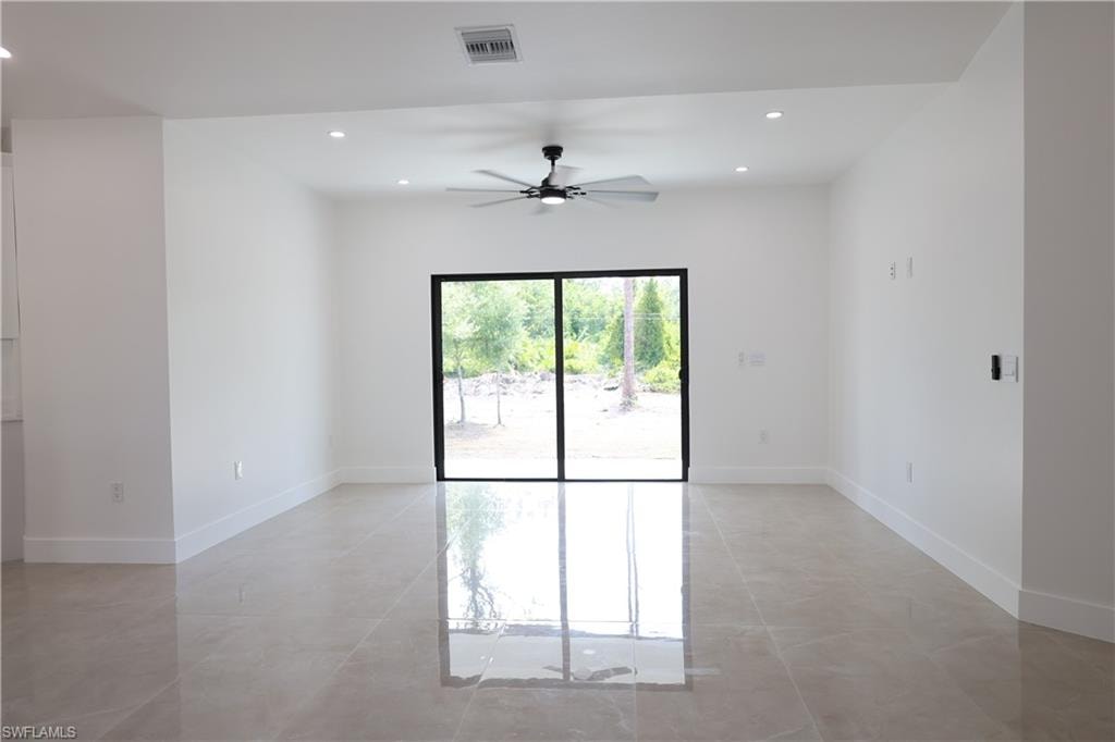 Kitchen featuring light stone countertops, decorative light fixtures, white cabinets, and recessed lighting