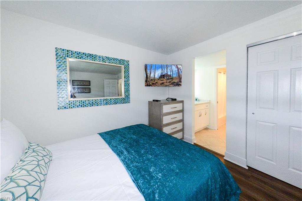 Bedroom featuring wood finished floors and connected bathroom