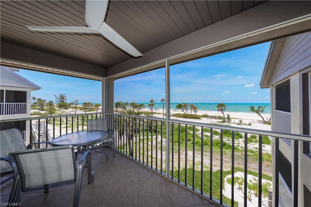 Balcony featuring view of water and beach