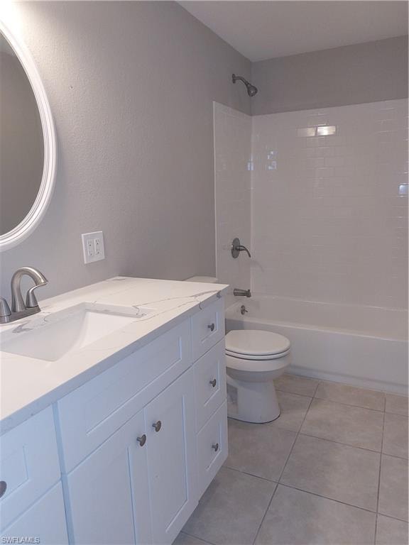 Bathroom featuring vanity, toilet, shower / tub combination, and tile patterned floors