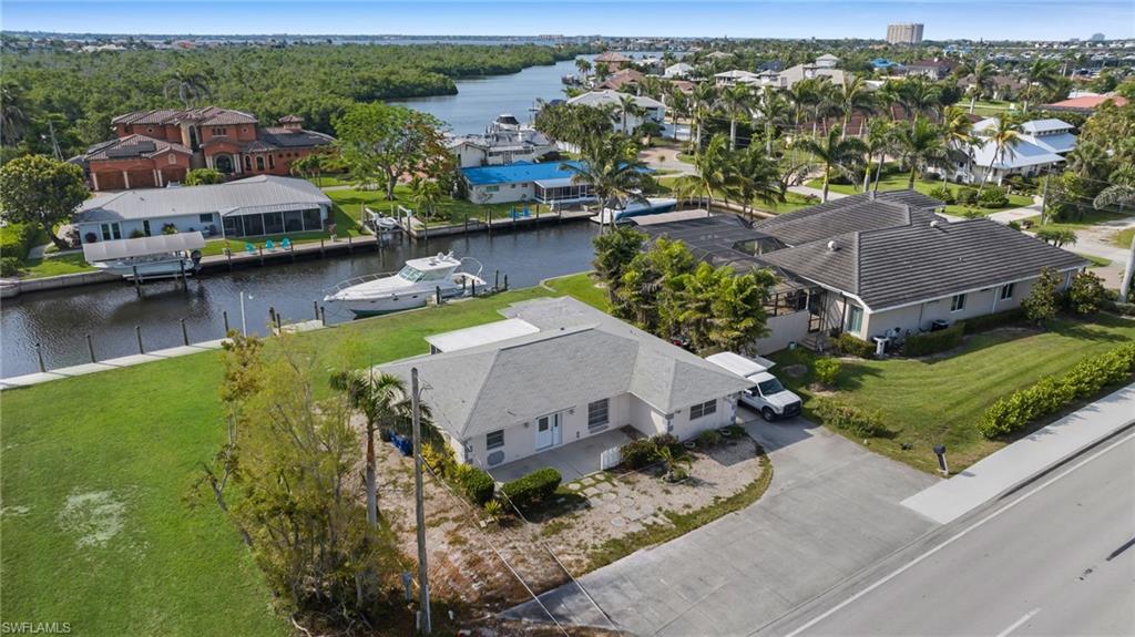 Aerial perspective of suburban area with a nearby body of water