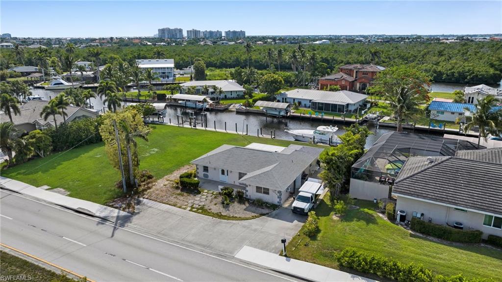 Aerial view of residential area featuring a nearby body of water