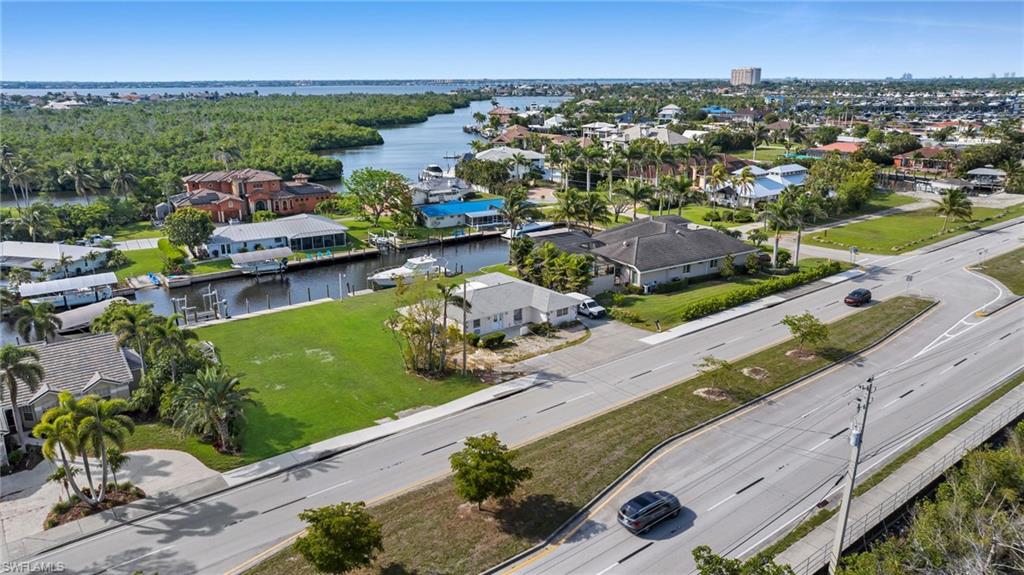 Aerial perspective of suburban area with a nearby body of water