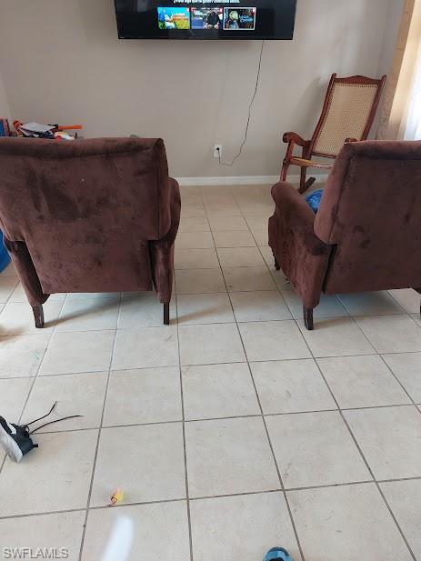 Living area with light tile patterned floors and baseboards