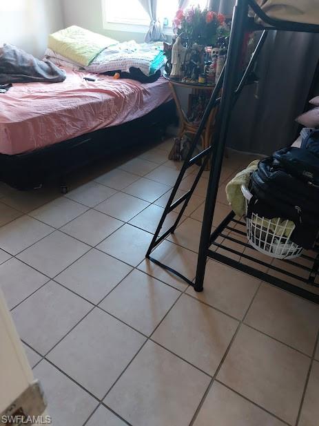 Bedroom with light tile patterned floors