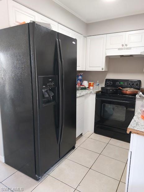 Kitchen featuring black appliances, under cabinet range hood, light countertops, white cabinets, and ornamental molding