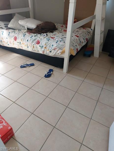 Bedroom with light tile patterned flooring