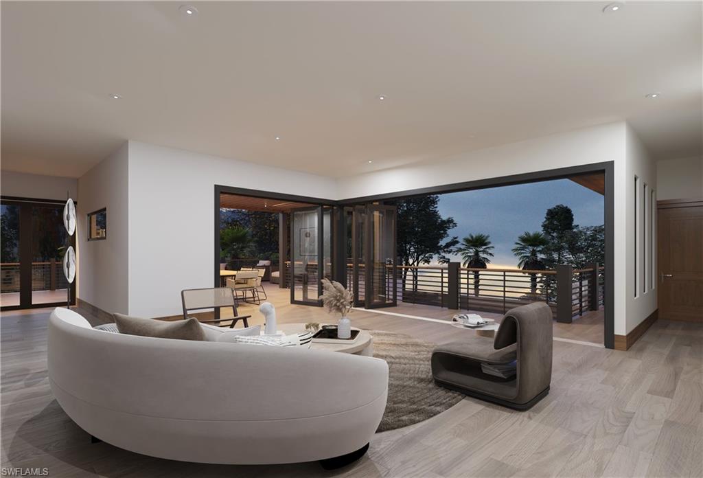 Living room with plenty of natural light, wood finished floors, and recessed lighting