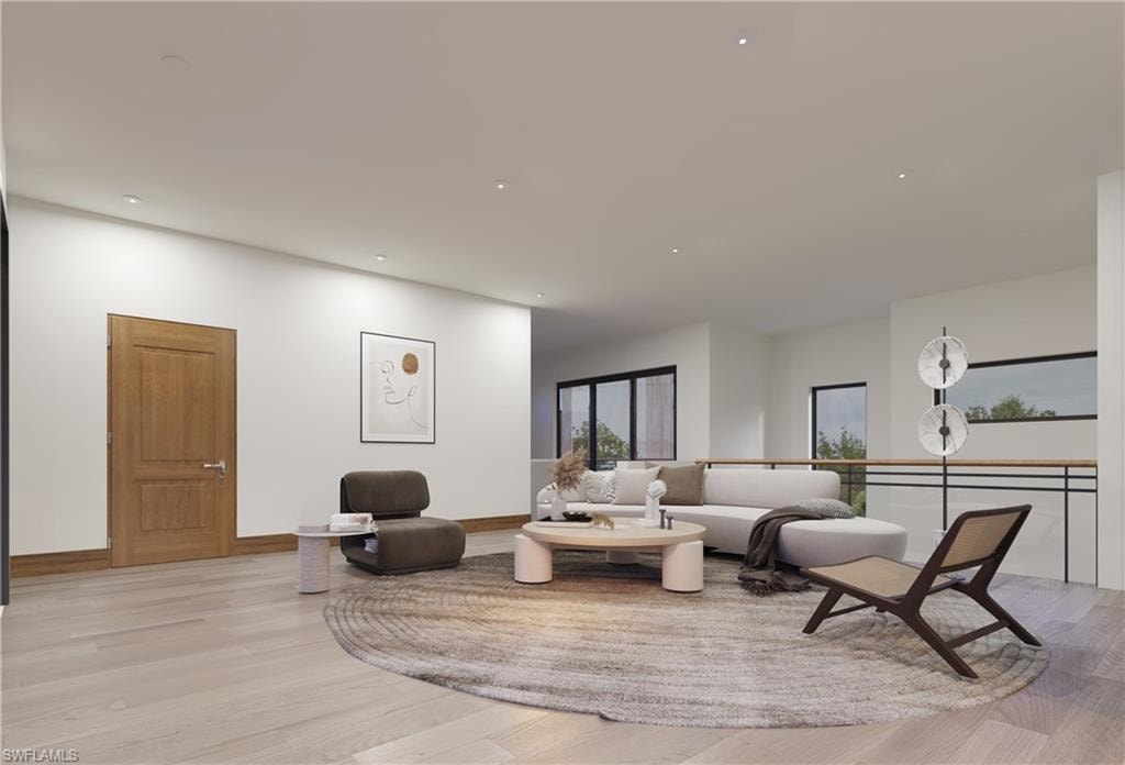 Living area featuring light wood finished floors, baseboards, and recessed lighting