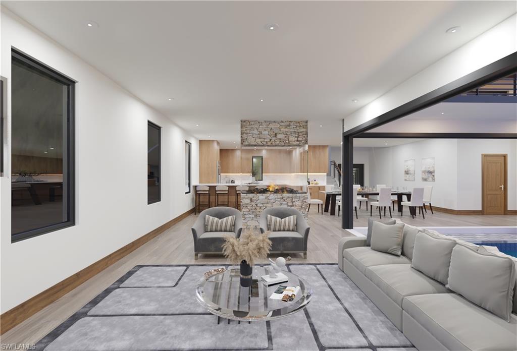 Living area featuring light wood-style flooring, baseboards, and recessed lighting