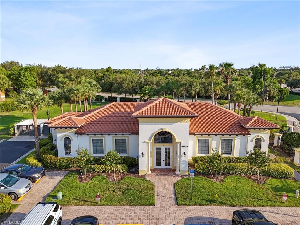 Mediterranean / spanish-style house featuring french doors, a tiled roof, and stucco siding