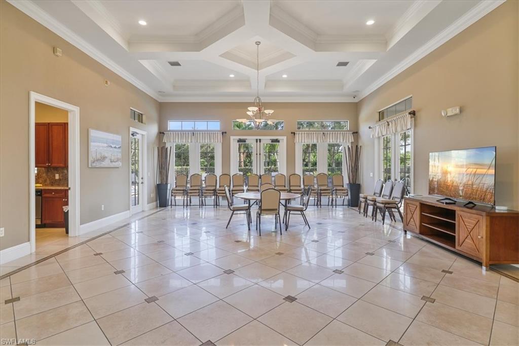 Dining room with french doors, a high ceiling, plenty of natural light, light tile patterned floors, and crown molding
