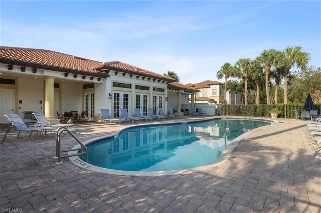 Community pool with french doors and a patio area