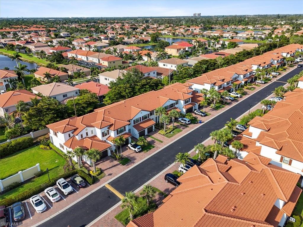 Aerial perspective of suburban area featuring a large body of water