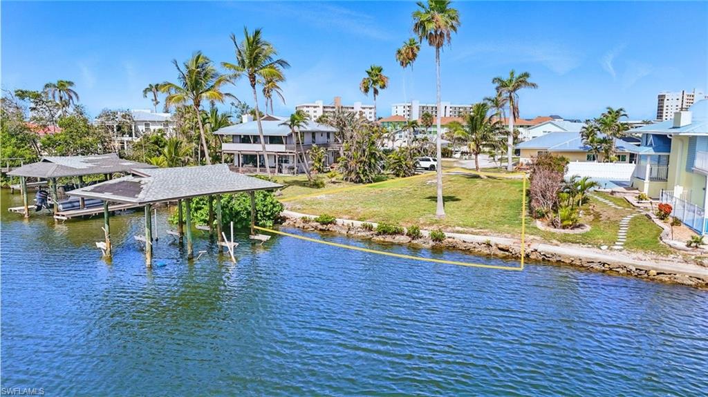Water view featuring boat lift and a dock -  VIRTUALLY ENHANCED