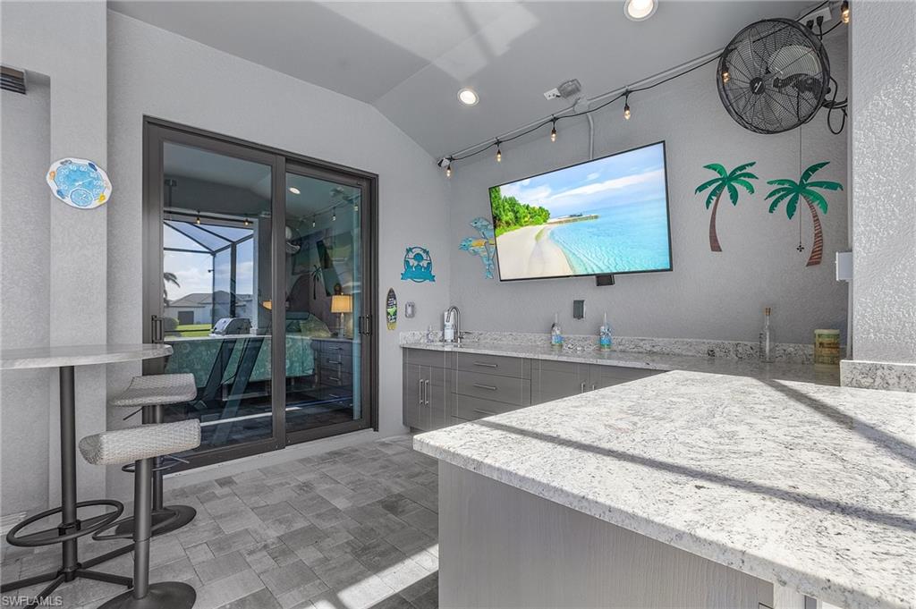Bathroom featuring vanity and vaulted ceiling