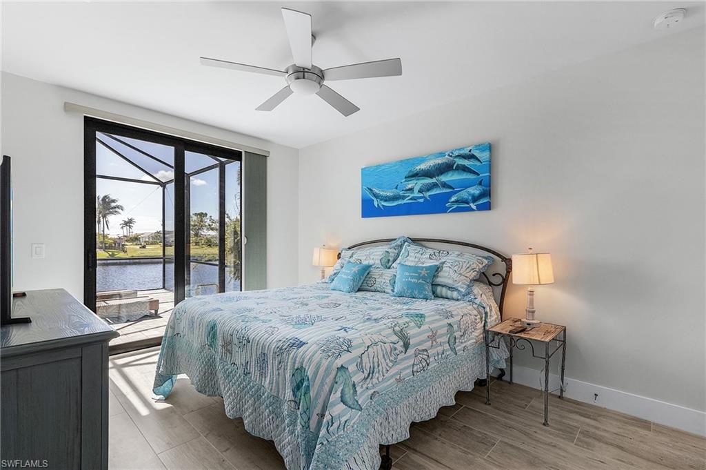Bedroom with tile flooring, a water view, and ceiling fan