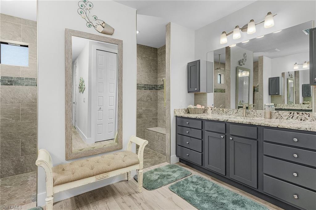 Bathroom featuring tile floors,and a tile shower