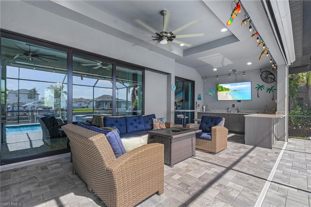 View of patio with ceiling fan and an outdoor hangout area