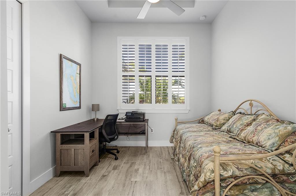 Bedroom featuring light tile flooring and ceiling fan