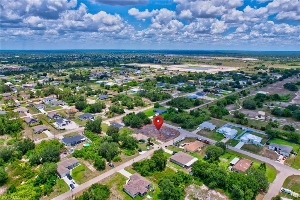 Aerial overview of property's location featuring nearby suburban area