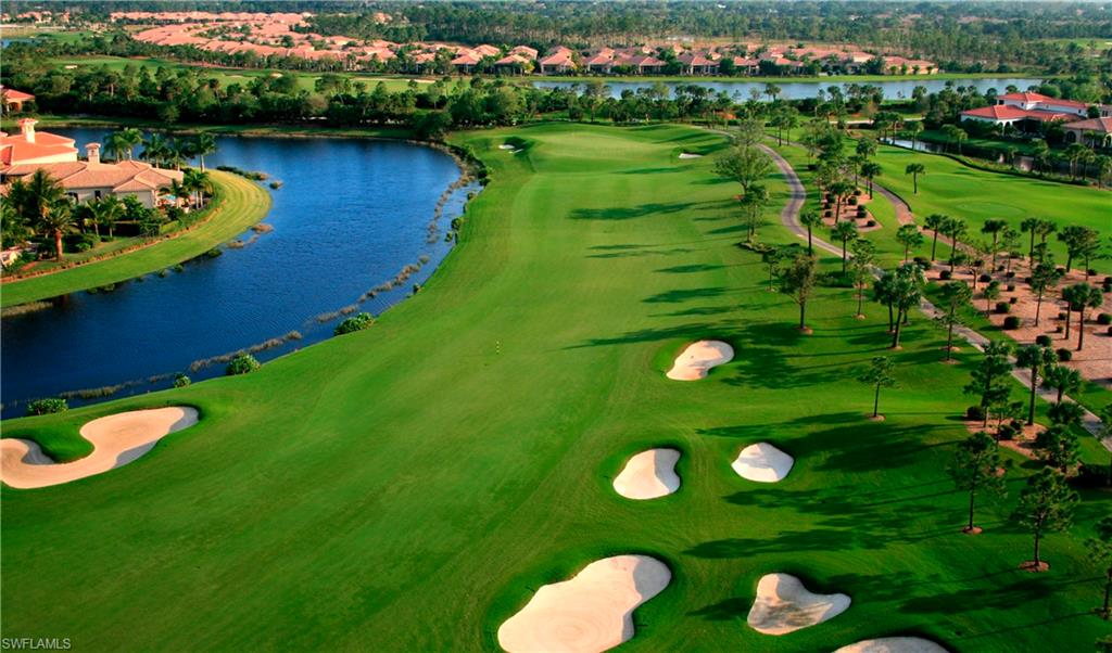 Aerial view of residential area with a golf course and a nearby body of water