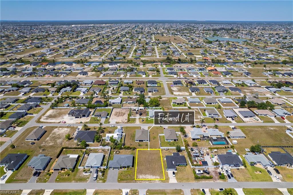 Aerial view of property's location featuring nearby suburban area