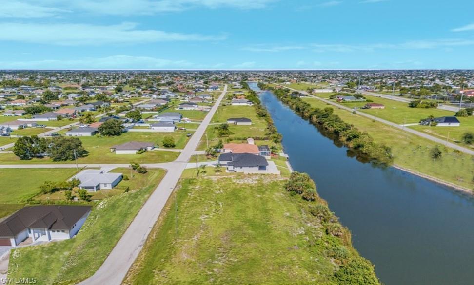 Aerial perspective of suburban area with a nearby body of water