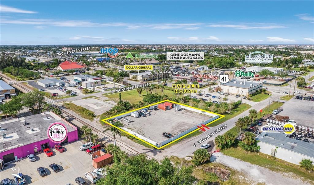 Aerial view of property's location featuring property boundaries highlighted and a commercial area