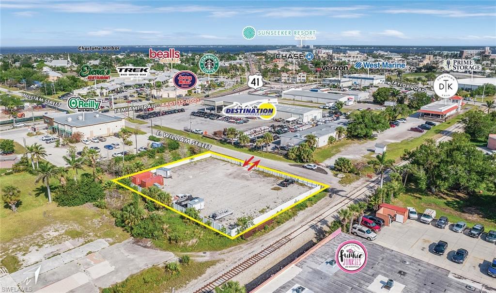 Aerial view of property and surrounding area with property parcel outlined